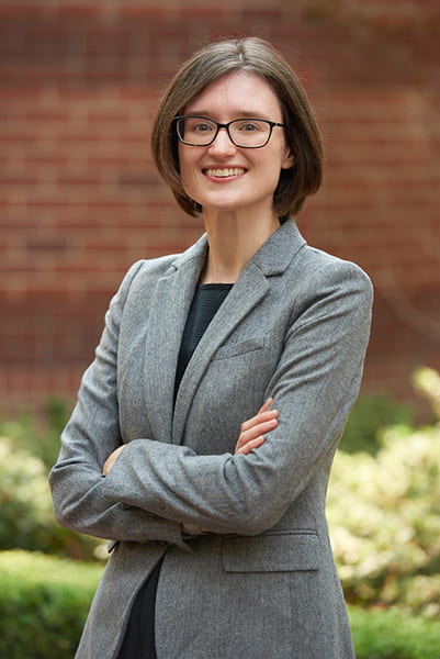 Headshot of Erin Miller, Assistant Professor of Law at USC Gould School of Law, outside with arms crossed, smiling at camera.